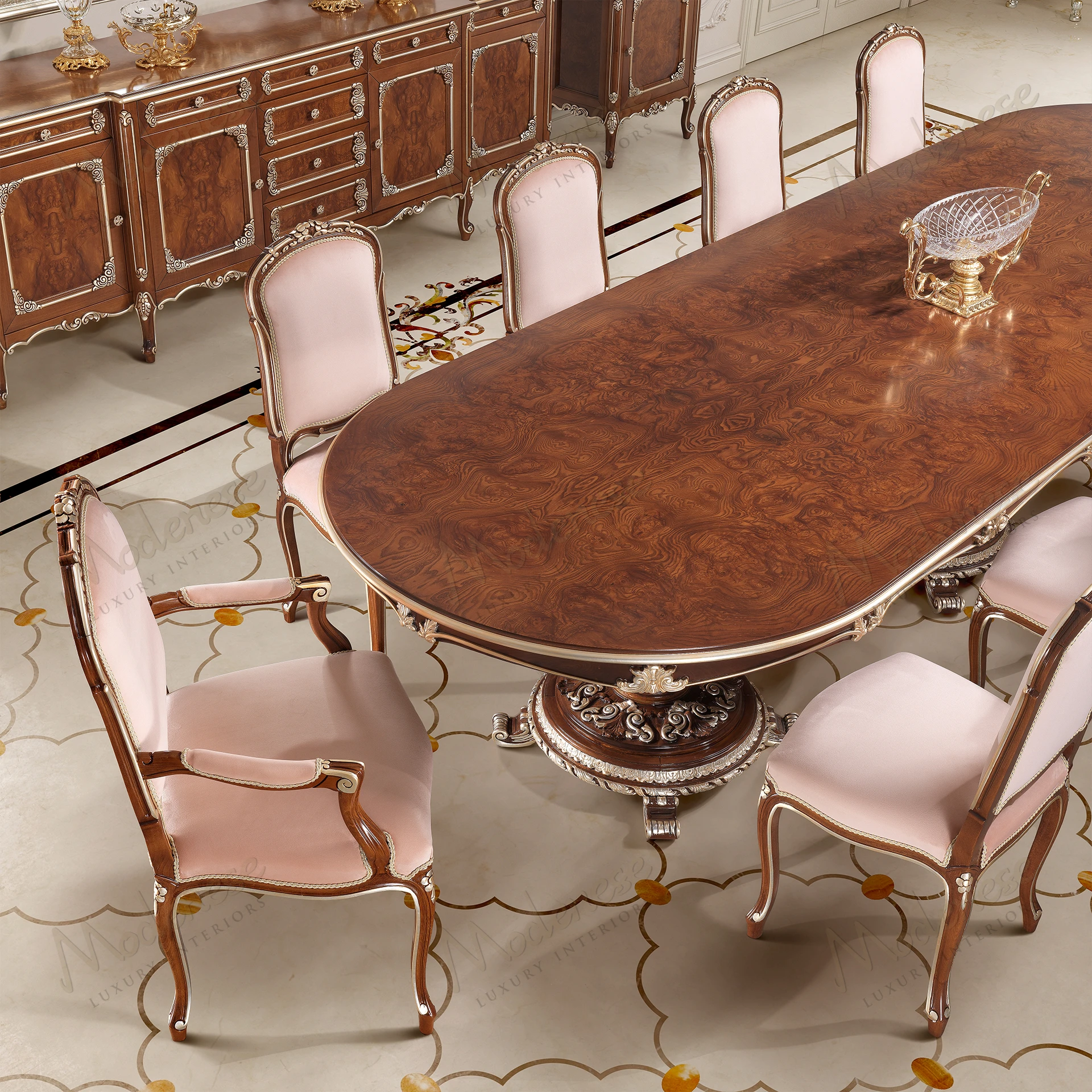 Elegant dining table with classic walnut finish and silver leaf details, featuring an artistic design with smooth surfaces. No fabric textures present